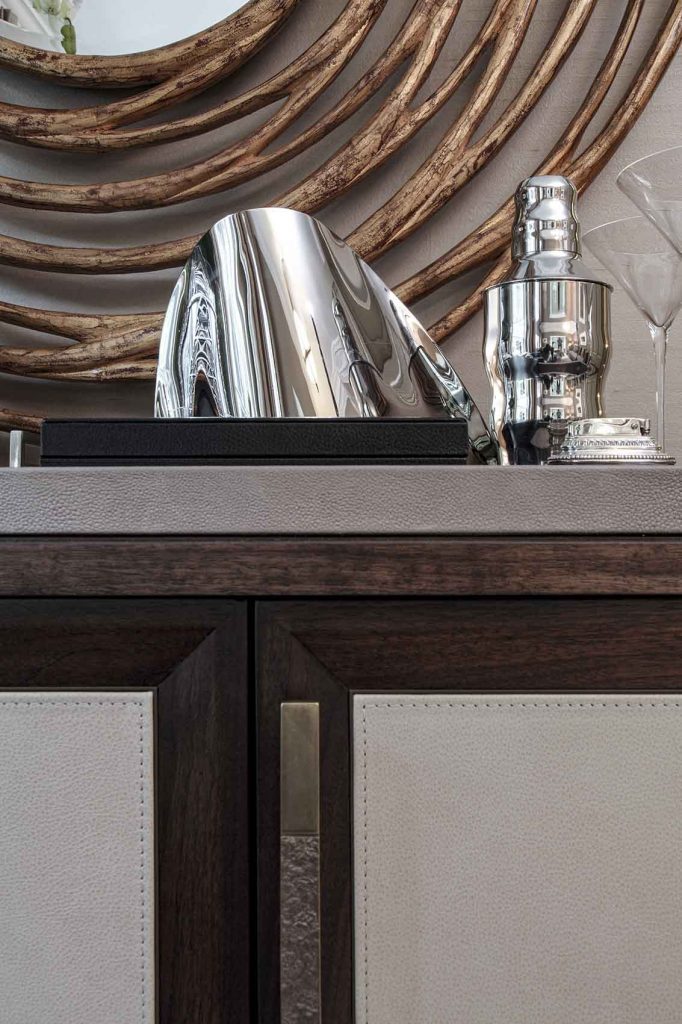 Detail showing dark stained walnut & saddle stitch leather, ice bucket and shaker