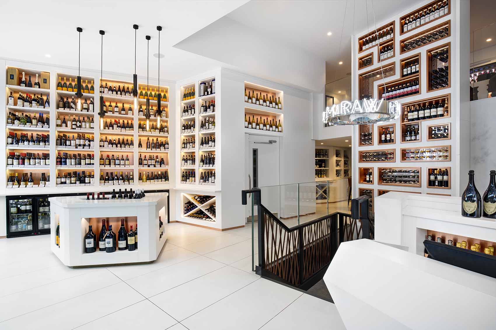 Full height wine display in white and copper with modern pendants