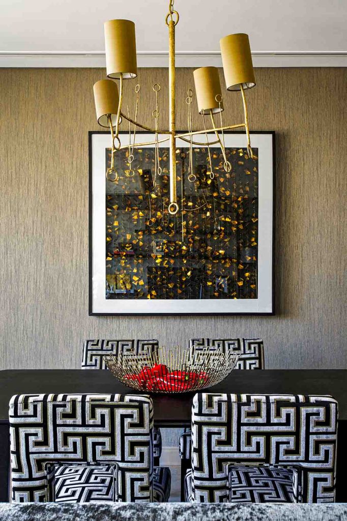 Taupe silk wall paper, gold and black artwork, luxury dining room, Greek key design velvet upholstery