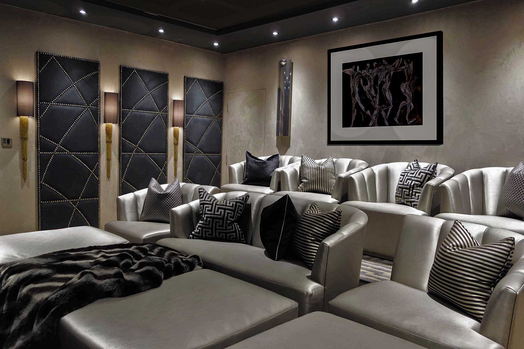 1930's inspired cinema room, suede walls, gold wall lights, gold leather chairs