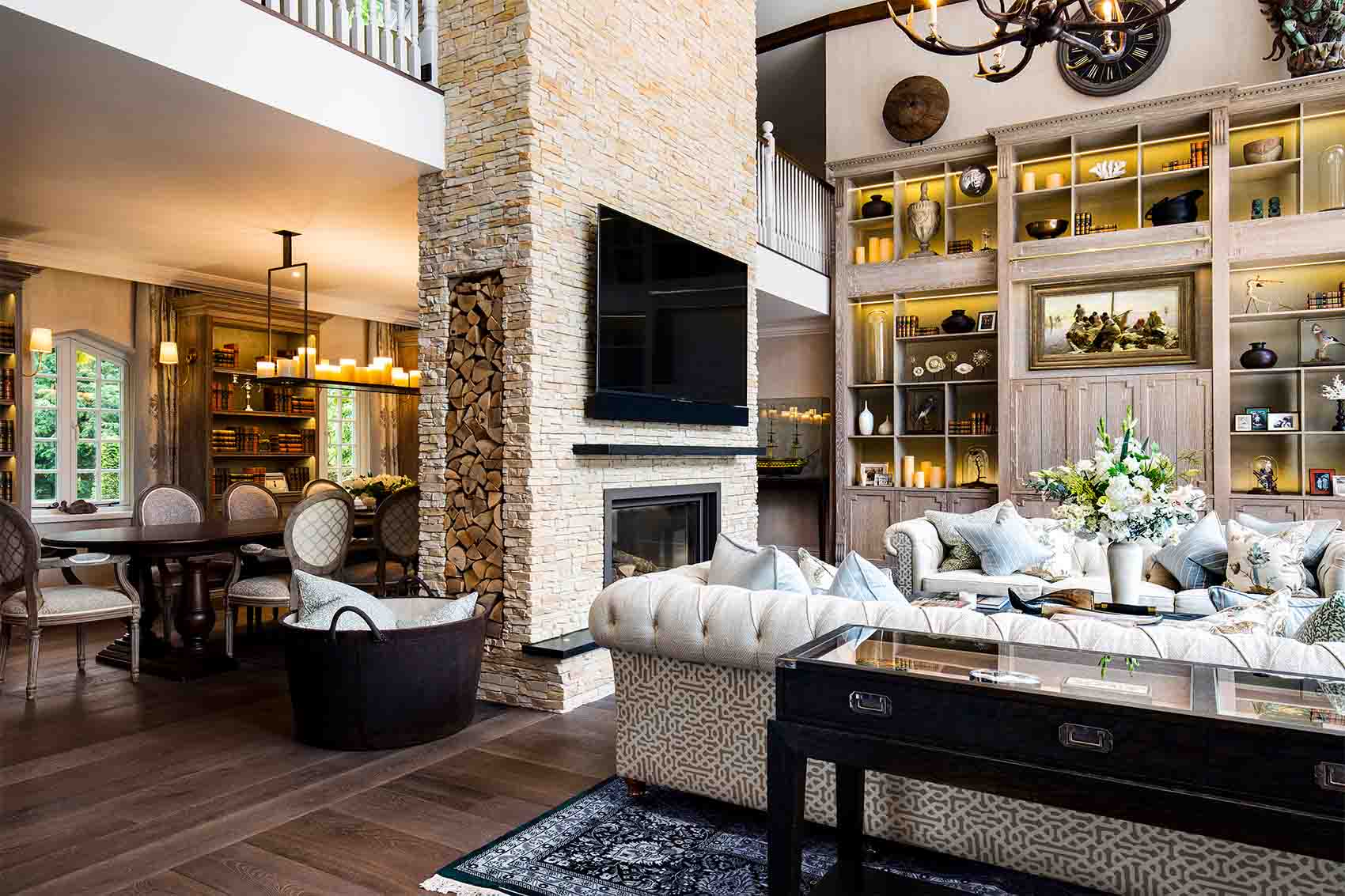 Open plan living dining space, full height distressed bookshelves, double fire place, silk rug, Rene Dekker