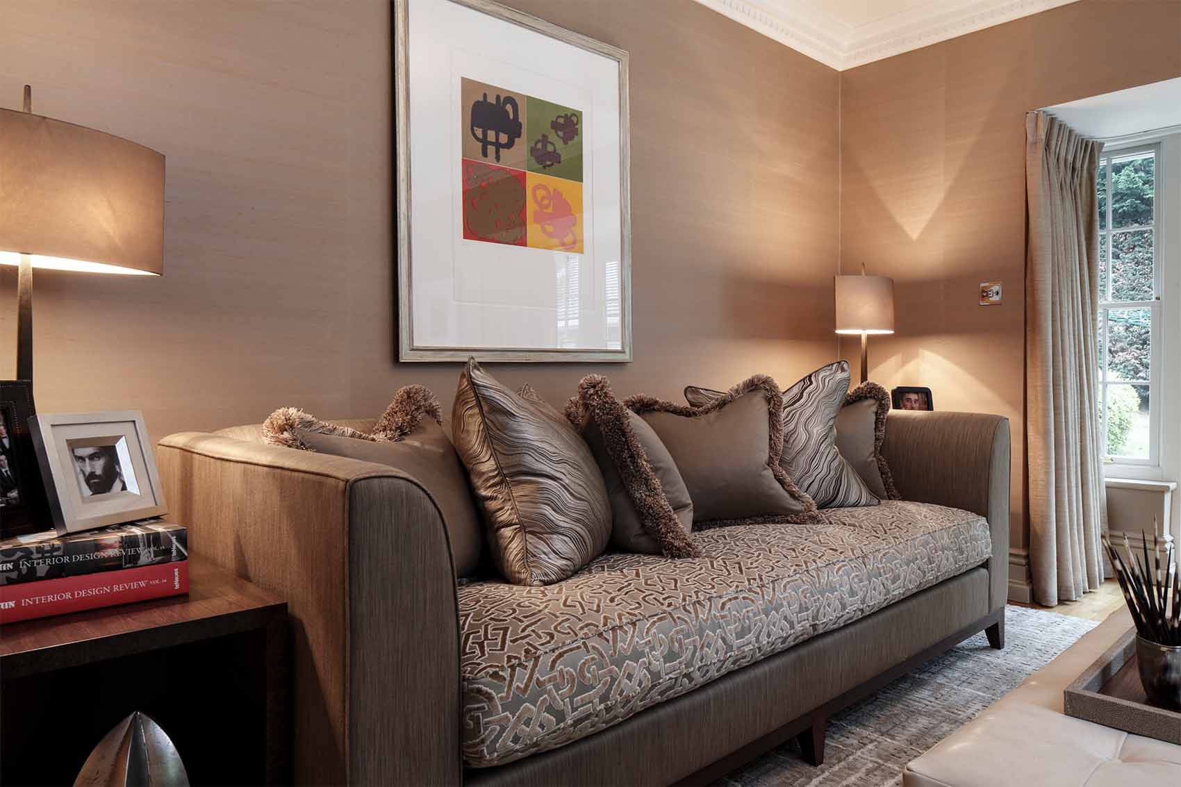 Gold silk wall paper, luxury living room, linen and velvet upholstered sofa, gold lamps