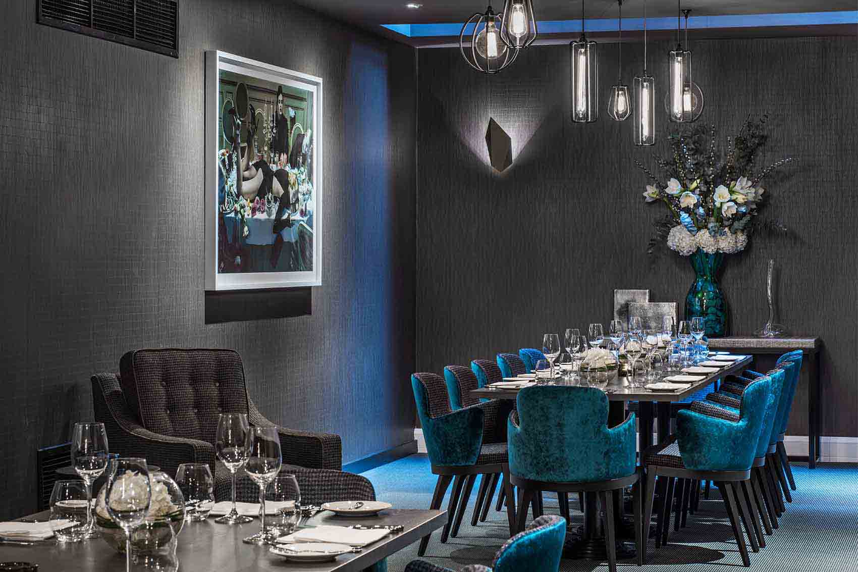 Private dining room, teal velvet chairs, photography artwork, top London design studio