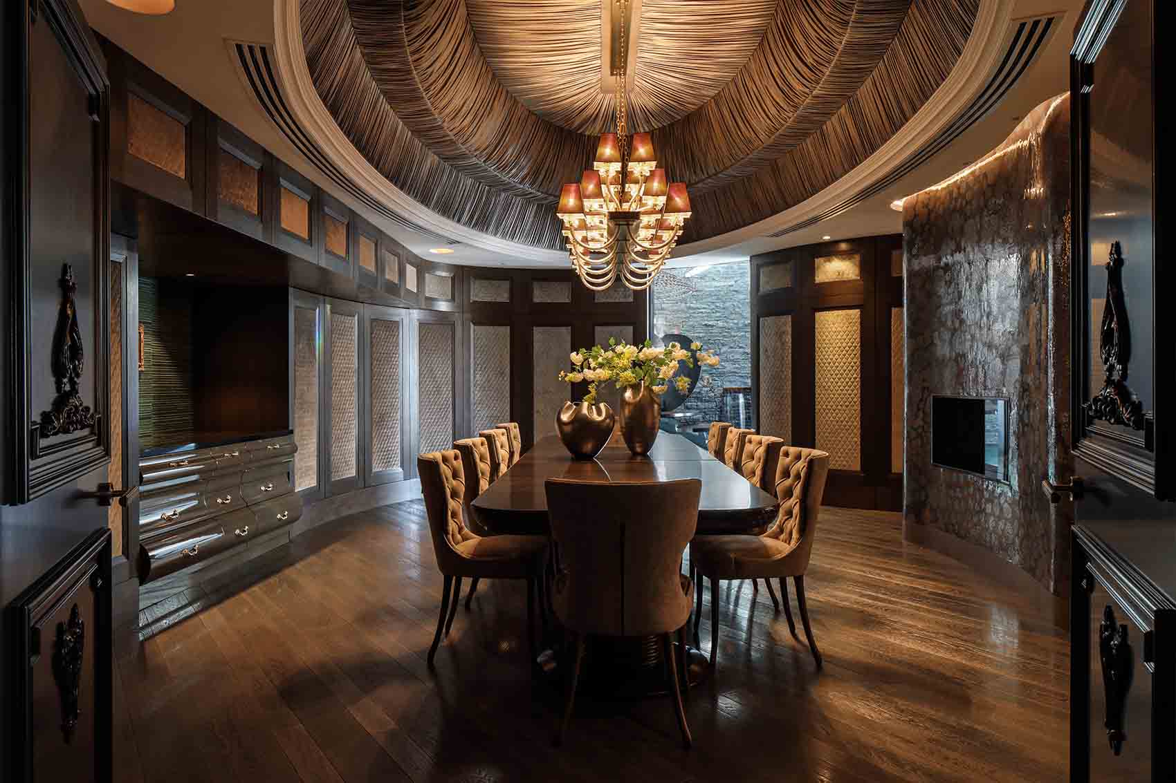 Glamorous dining room, tented ceiling, dark timber panels with quilted velvet insets