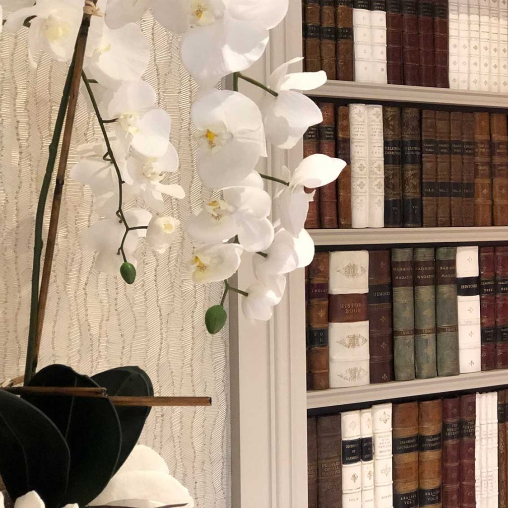 Faux books, white orchid in bowl, Armani wall paper, modern farm house