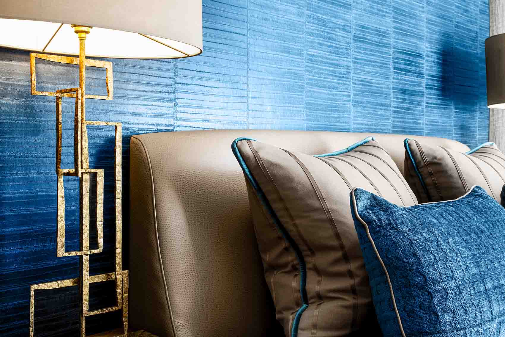 Teal eel skin wall paper, luxury high end velvet scatter cushions. Silk shades, gold lamps