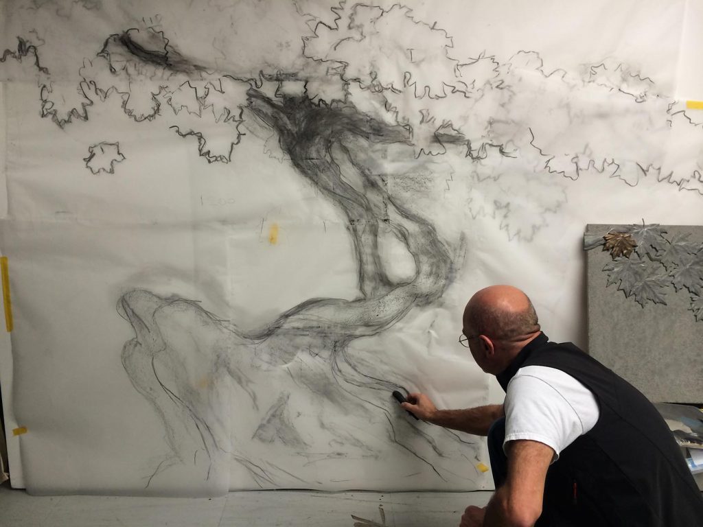 Artist drawing initial full scale sketch of bonsai tree, white paper,