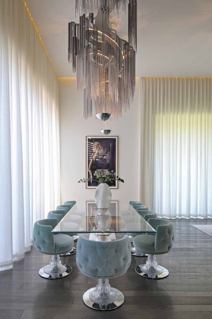 Bespoke Willowlamp chandelier, triple height ceilings with cascading curtains, metal floor