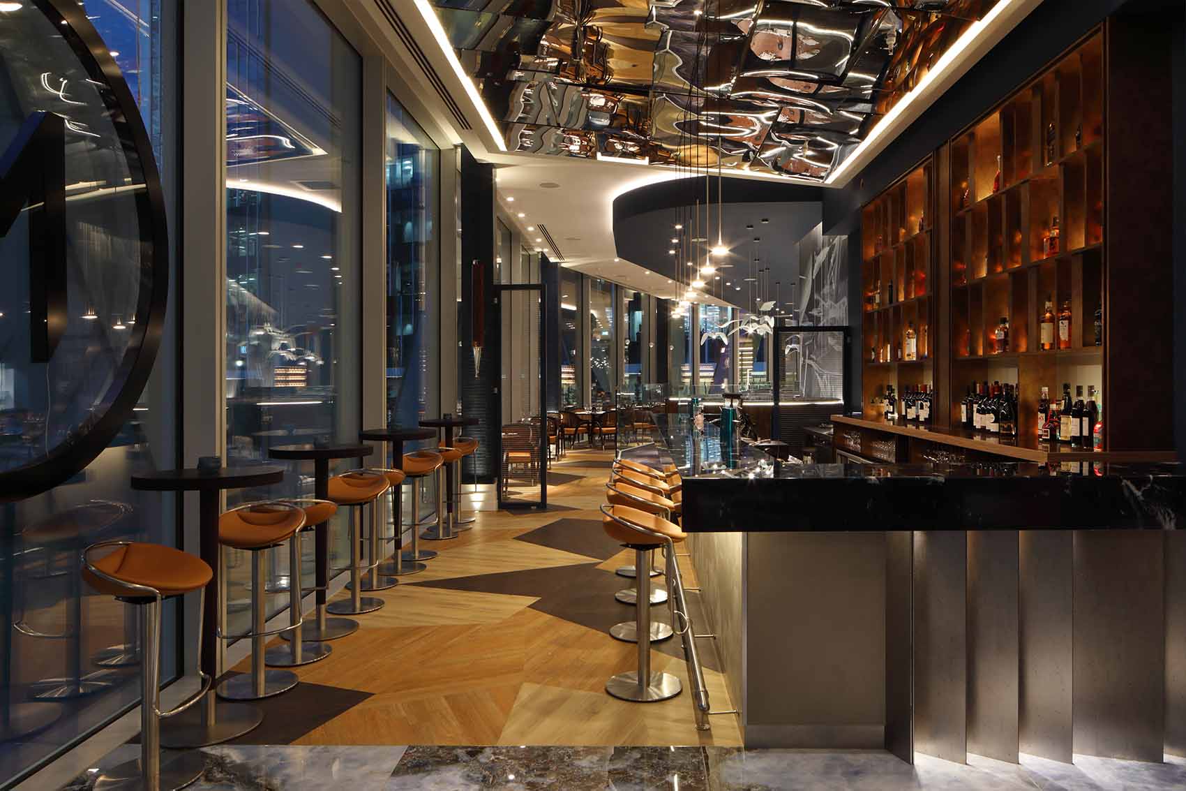 Stylish bar design, metallic details, concrete front, mirror ceiling, Rene Dekker Design