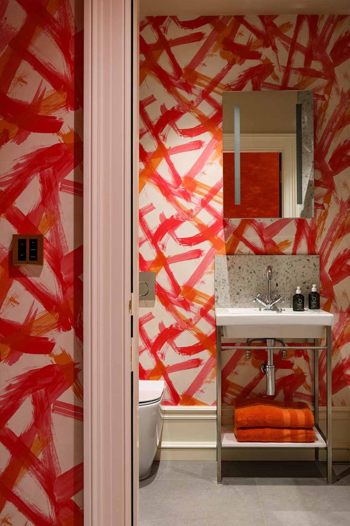 Bright pink, orange and red wall covering, Rene Dekker design, guest bathroom, lighting design